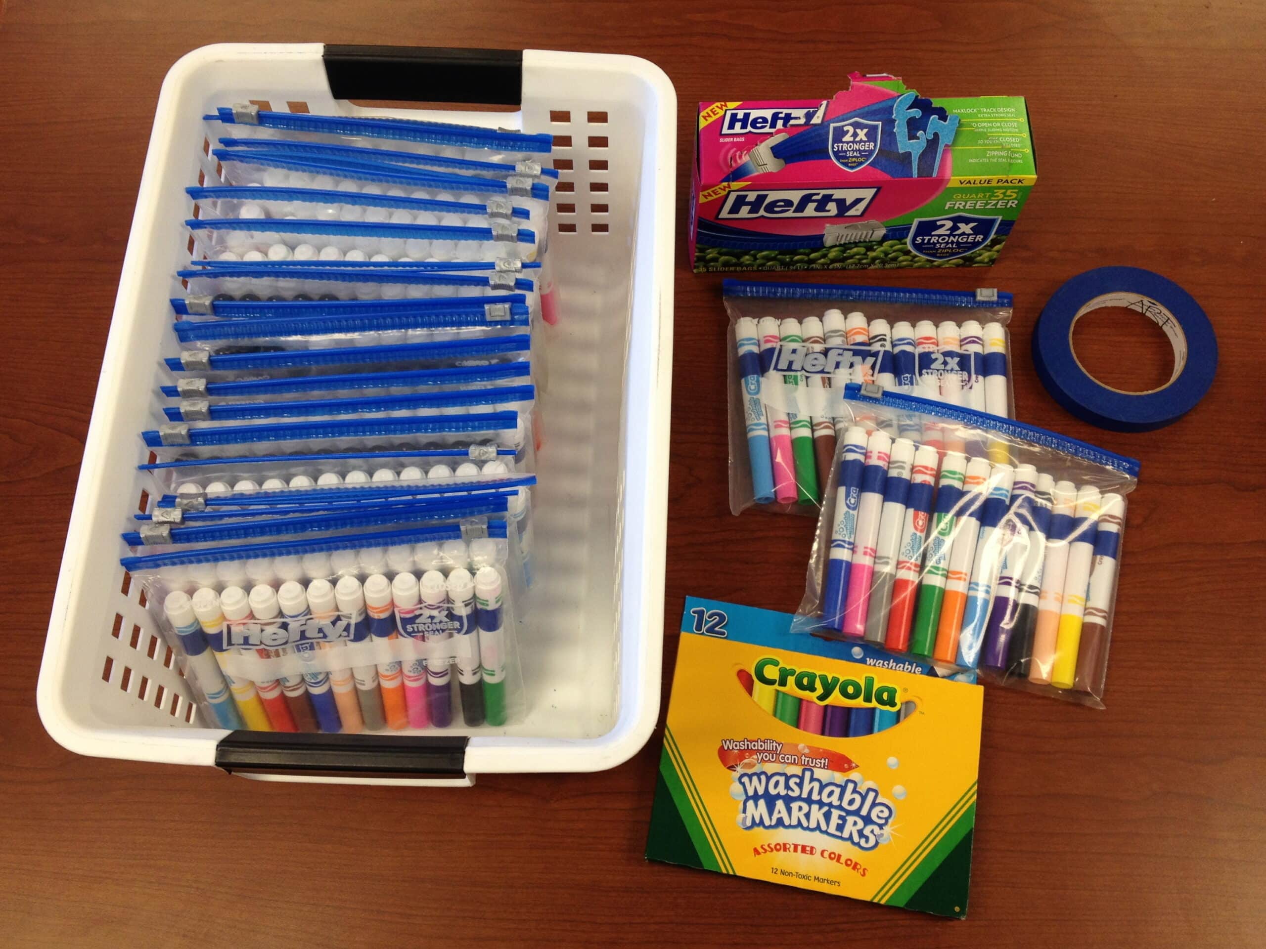 Crayola Markers in plastic bags in a tub